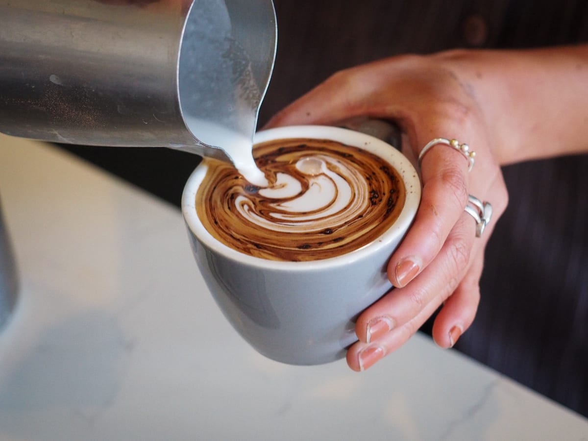 Cass making a cappuccino at the Sample Coffee Pro Shop.